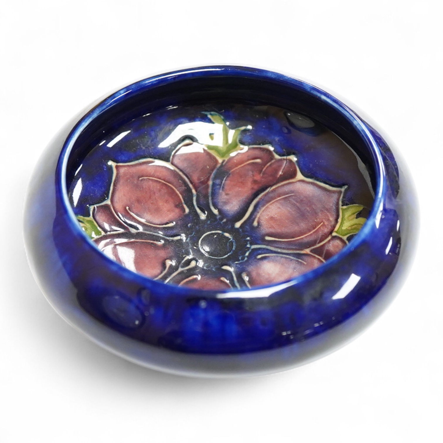 A small Moorcroft bowl in the anemone pattern, stamped to the base, 11cm in diameter
